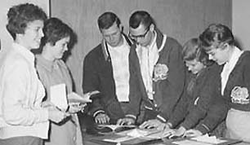 1950s students areound table with documents